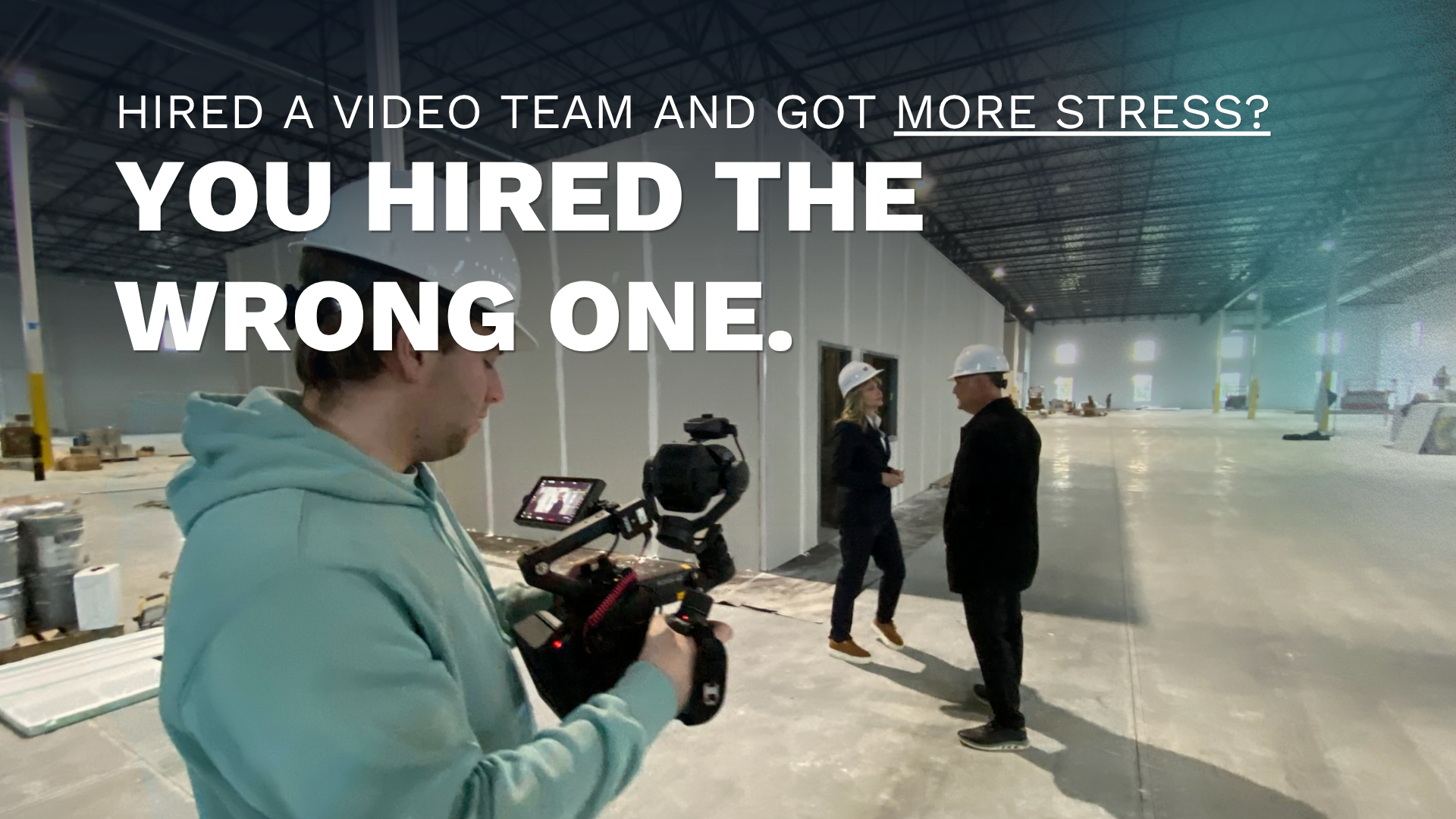 A Double Take Video camera operator filming 2 people in a warehouse